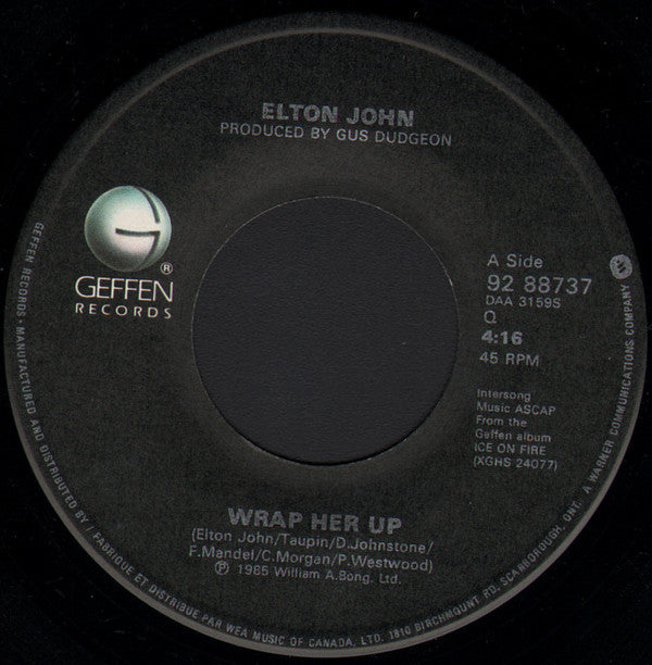 Elton John : Wrap Her Up / The Man Who Never Died (7", Single)