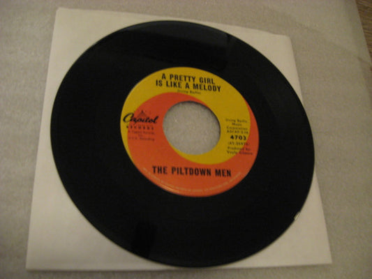 The Piltdown Men : A Pretty Girl Is Like A Melody (7", Single)